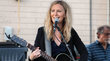 Florence Dore playing the guitar.